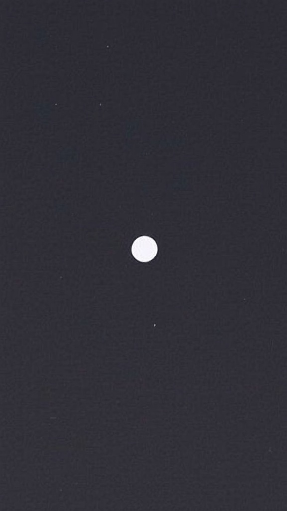 A minimalist card design featuring a white circle on a dark background, emphasizing the use of negative space.
